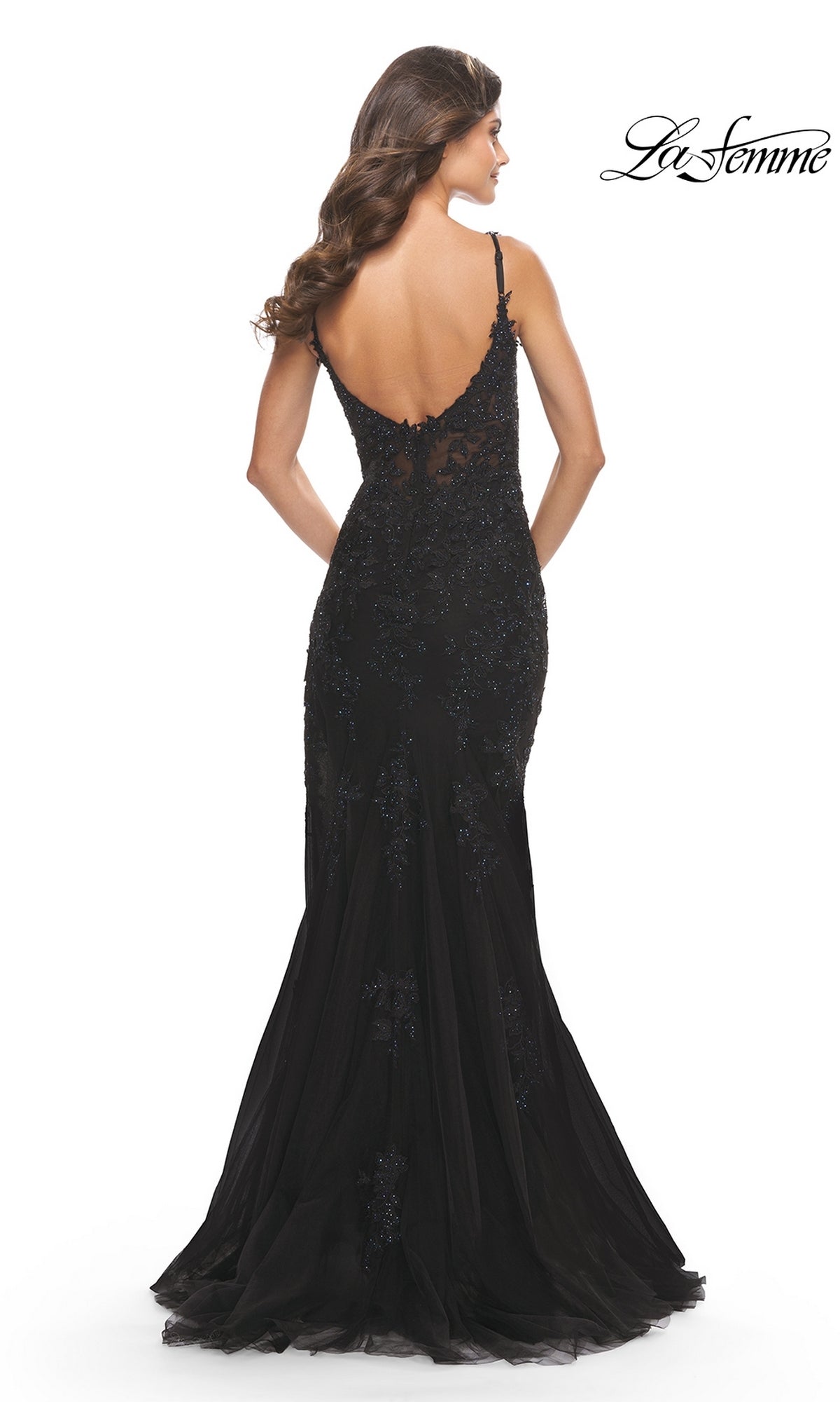 A woman wears the La Femme Sheer-Corset-Bodice Long Prom Dress 30767, a floor-length black fitted gown with lace embroidery, thin straps, and an open back. The La Femme logo is in the top right corner.